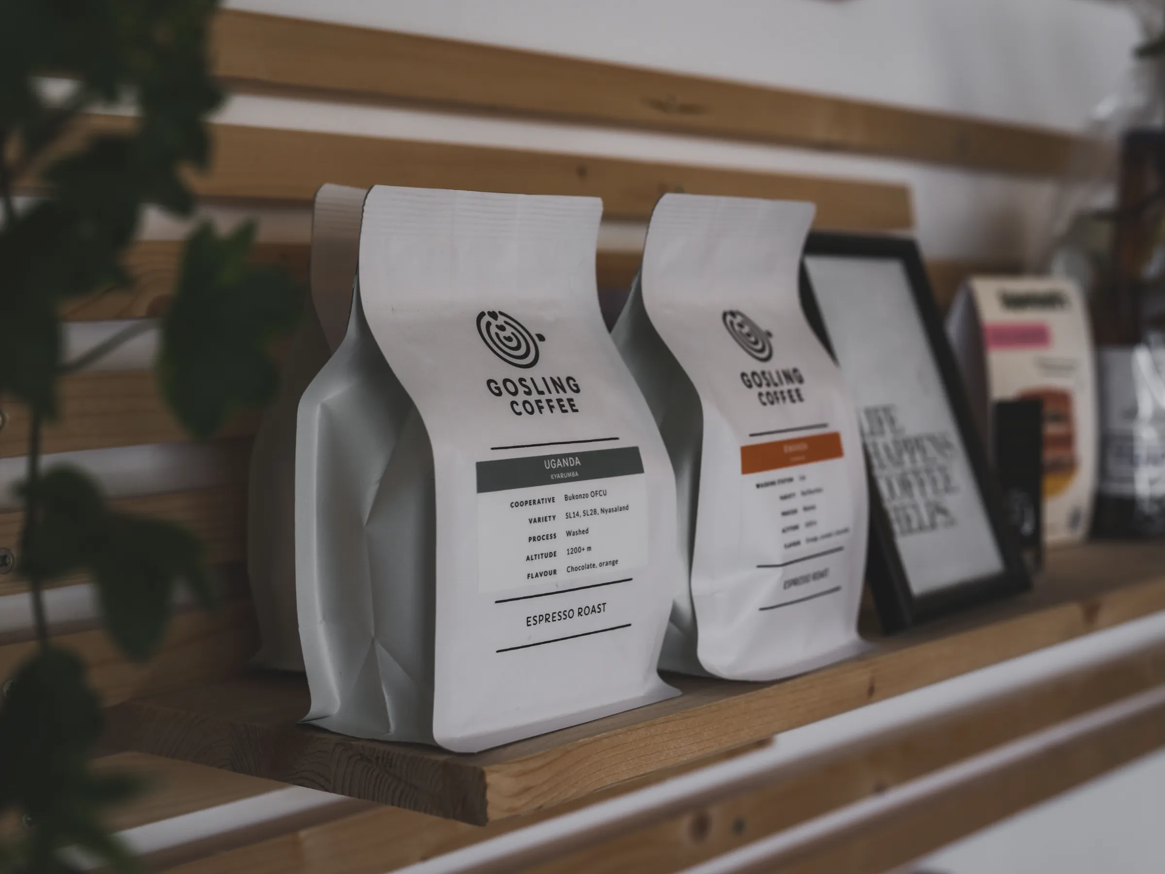 White coffee bags with labels on a wooden shelf