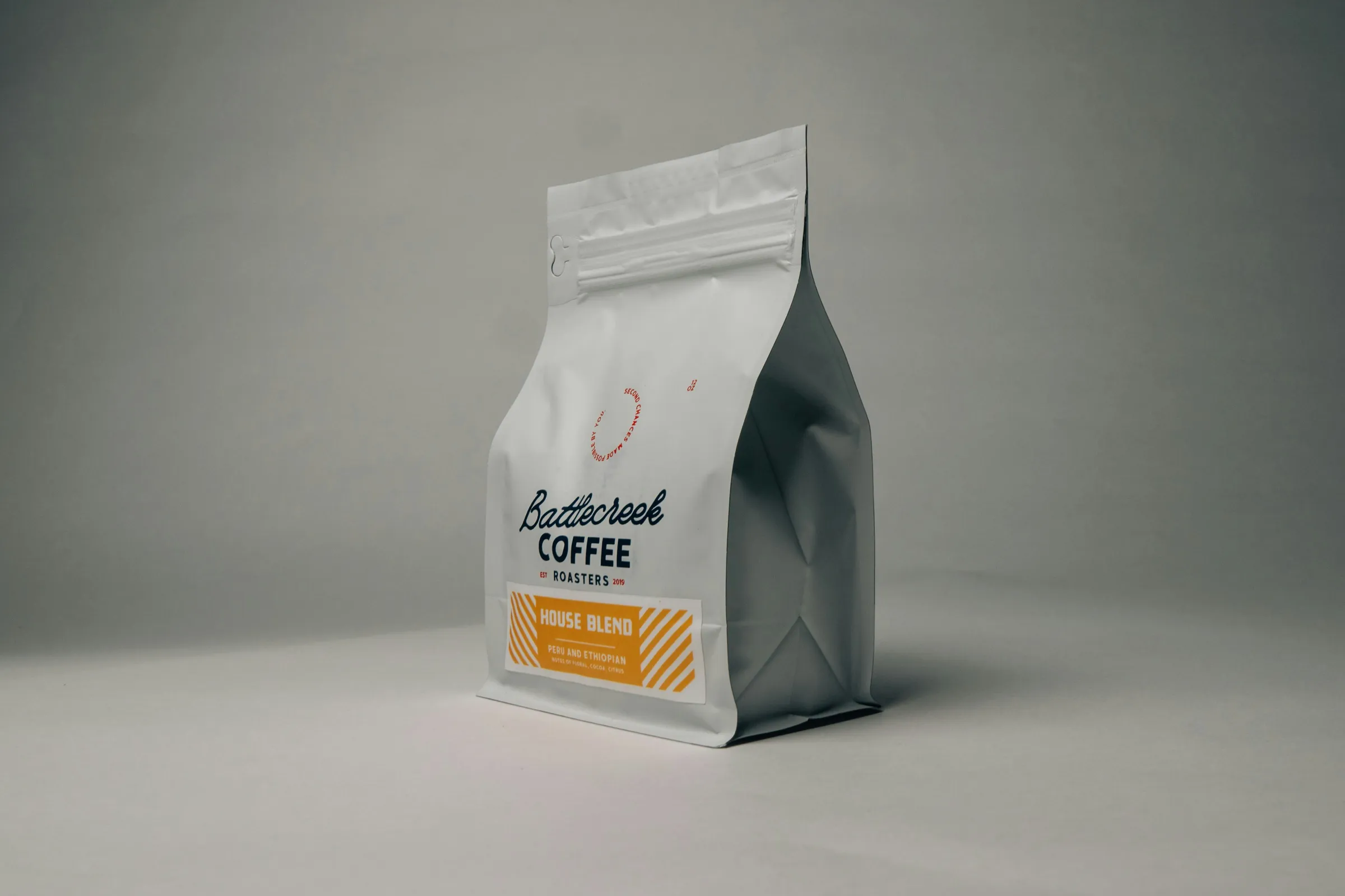White flat-bottom coffee pouch with a printed blend label