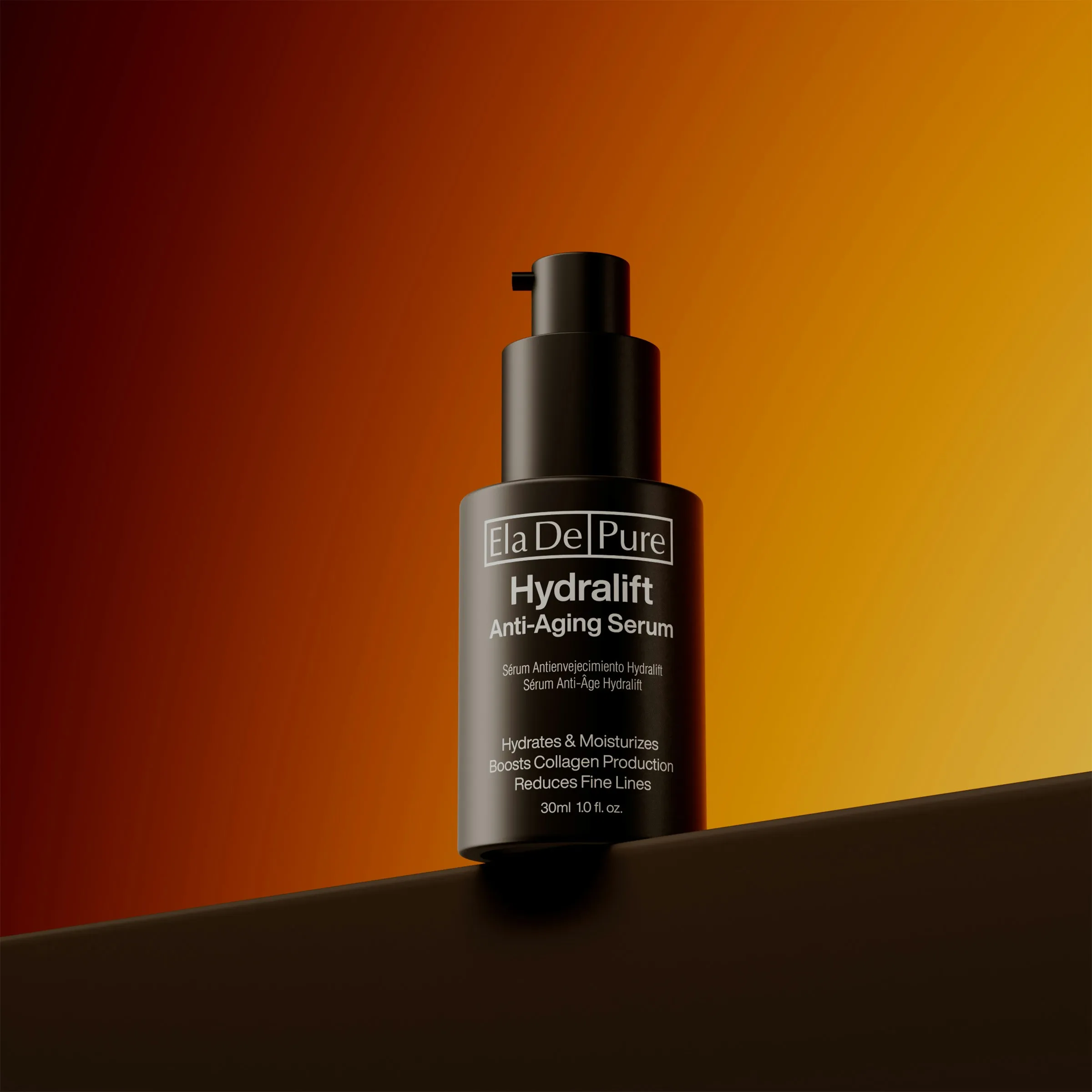 Black airless serum pump bottle with white print on an orange gradient