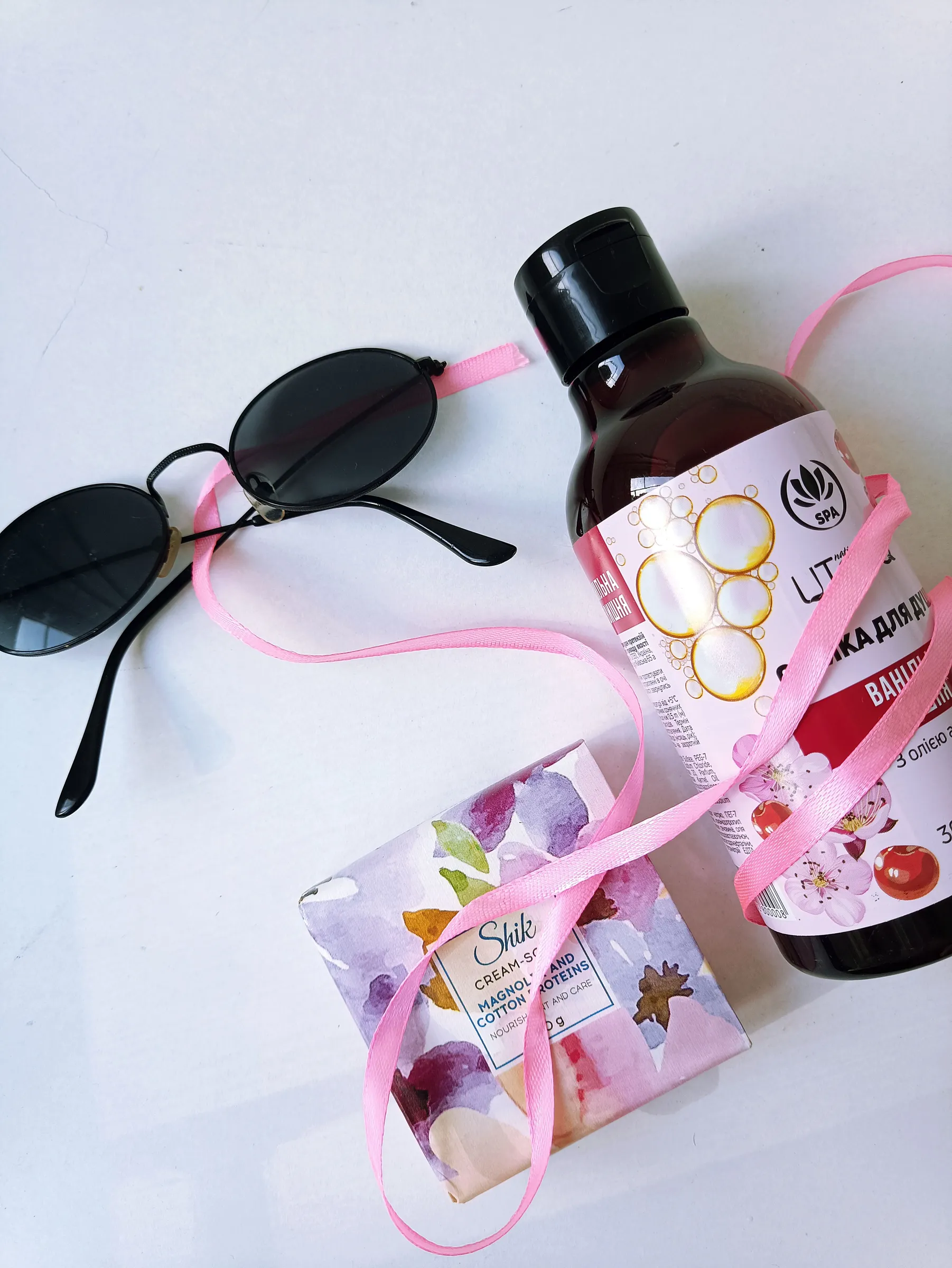 Wrapped soap and body wash bottle tied with a pink ribbon