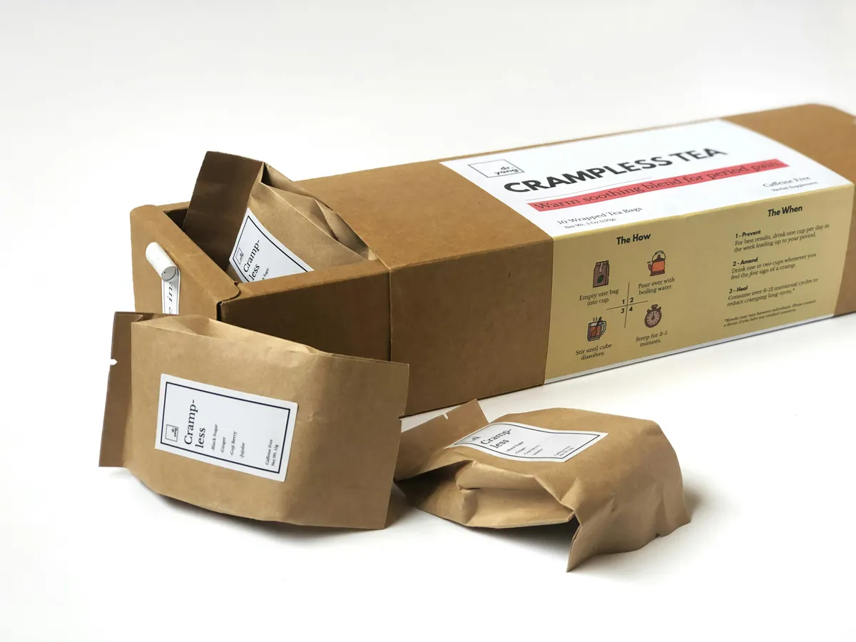 Long kraft tea box with a printed label and kraft tea pouches with white labels