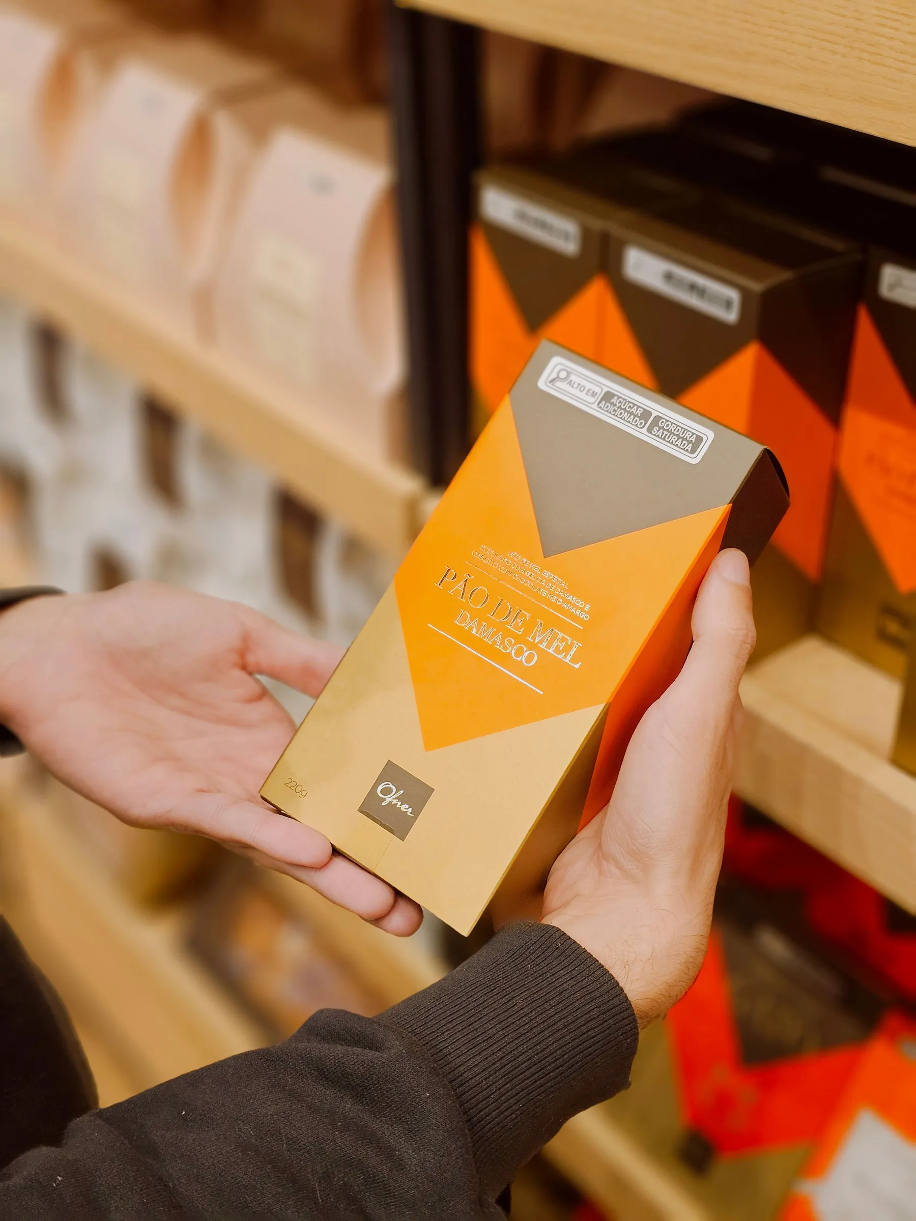 Printed carton held in front of a retail shelf