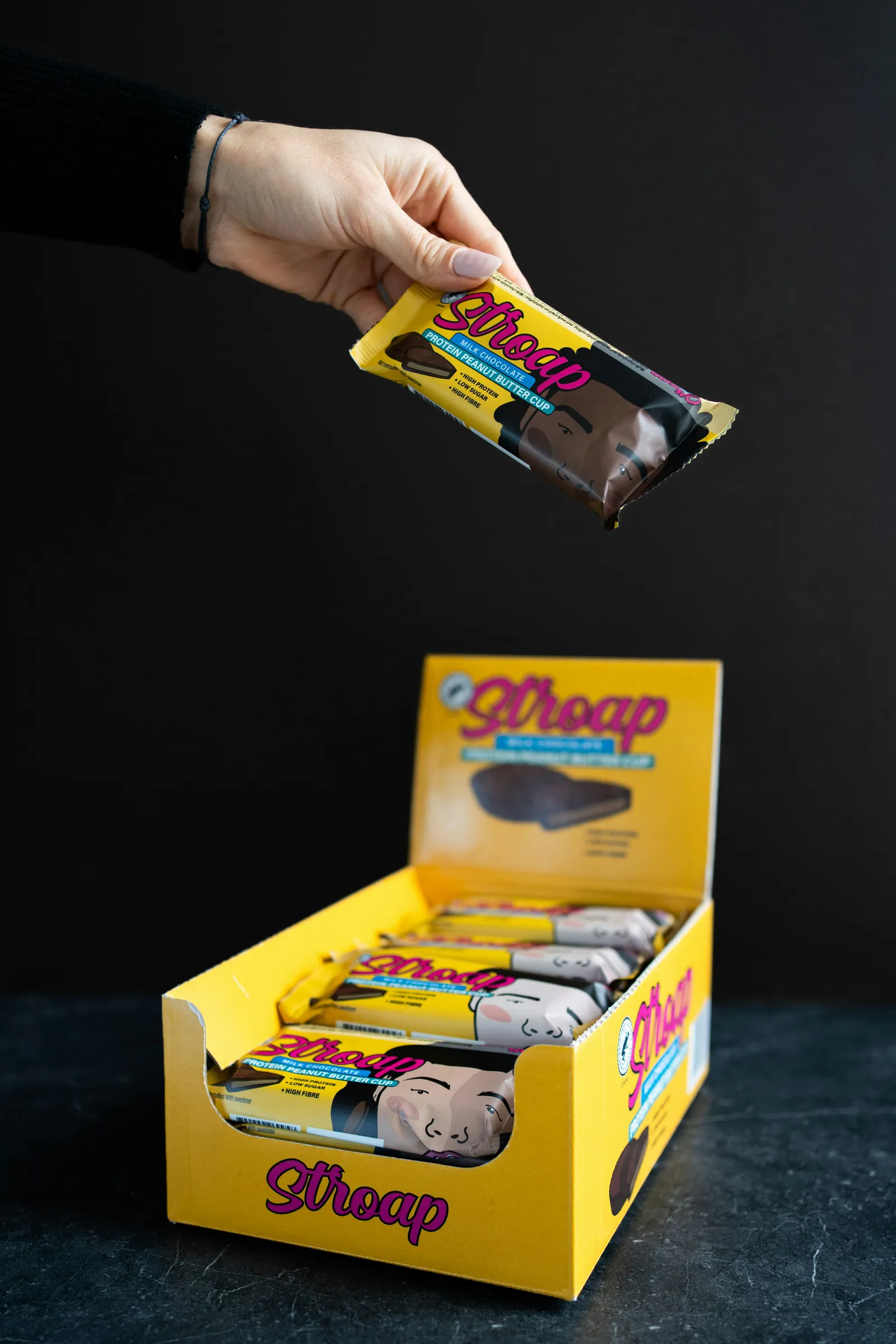 Yellow printed counter display box filled with wrapped chocolate bars
