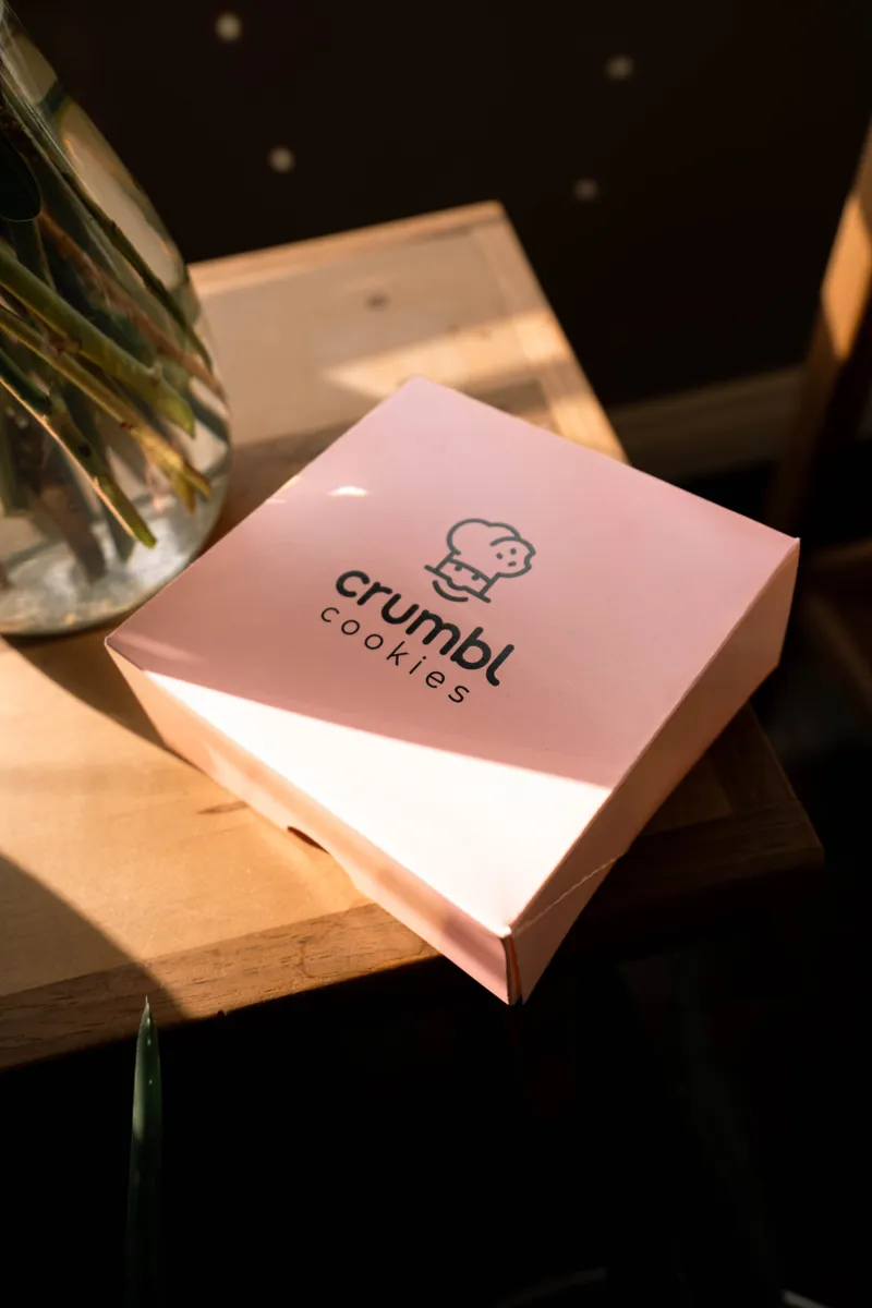 Pink printed cookie box on a sunlit table