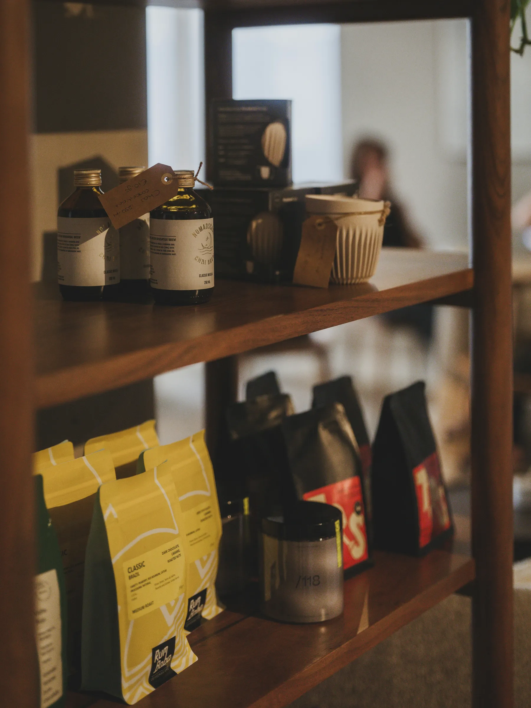 Café shelf with printed coffee bags, bottles and cups